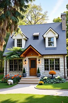 Front of stone cottage with lush garden and triangular roof. The undeniable charm of cottage homes brings a rustic fairytale to life with each brick and beam.