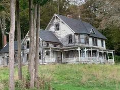 an old house is surrounded by trees and grass