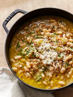 a pot filled with beans and parmesan cheese