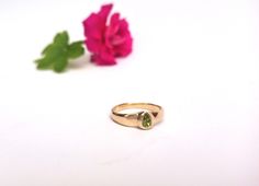 "Beautiful and unique solid gold ring signet ring set with pear-shaped peridot, alternative engagement or wedding ring. This wide 14K yellow gold ring is set with a pear-shaped light green peridot. The ring's wide design and the color of the peridot give this ring a certain air of majestic and quiet confidence. This ring is comfortable and noticeable and will be great for everyday use, as for a special occasion. It can also be a modern engagement ring. This ring will be a perfect gift for a stro Yellow Gold Peridot Stackable Rings For Anniversary, Green Bezel Set Signet Ring For Wedding, Green Signet Ring With Bezel Setting For Wedding, Yellow Gold Signet Ring For May Birthstone, Green Bezel Set Signet Ring For Promise, Green Signet Ring With Bezel Setting For Promise, Classic Gold Ring With Peridot, Yellow Gold Peridot Diamond Ring, 14k Gold Hallmarked Ring For May Birthstone