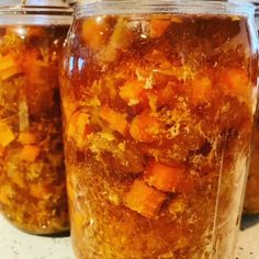 three jars filled with food sitting on top of a counter