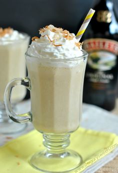 two glasses filled with whipped cream on top of a table