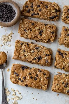 oatmeal bars with chocolate chips on top and spoon next to each other