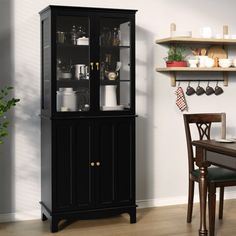 a black china cabinet with glass doors in a dining room