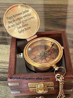 a wooden box with a compass and keychain in it that says happy retirement