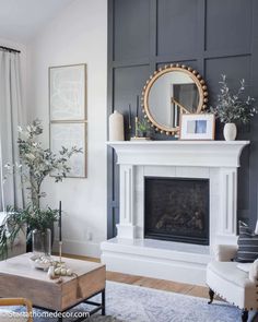 a living room with a fireplace, mirror and pictures on the wall above it's mantle