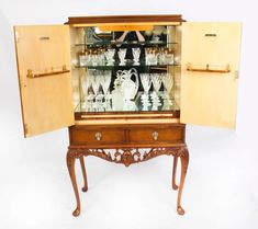 an antique china cabinet with glass doors and drawers