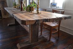 a wooden table with candles on it in a room