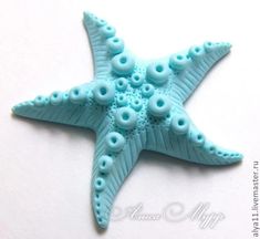 a starfish made out of plastic beads on a white surface