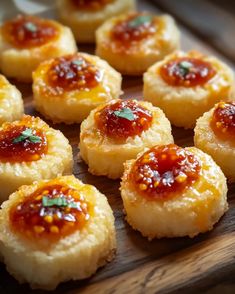 small pastries are arranged on a cutting board with ketchup and green garnish