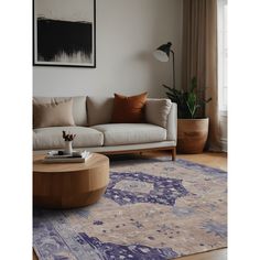 a living room with a couch, coffee table and rug