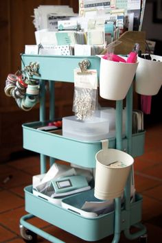 a blue cart with cups and other items on it