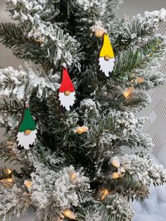 christmas ornaments are hanging from the top of a pine tree