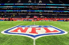 a football field with the nfl logo on it and people in the stands watching from the sidelines