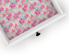 an open white box with pink and blue flowers on it