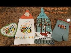 three oven mitts are sitting next to each other on a counter top with an owl design