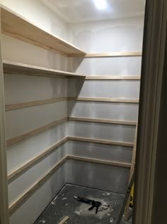 an empty room with shelves and tools in it