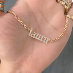 This unique personalized Old English font nameplate cut-out necklace is composed of 14K solid gold and beautifully pavé set with genuine GVs1 quality natural real Diamonds. This pendant is complemented by a durable 14K solid gold adjustable chain or can be purchased as a charm alone without the chain under the "Length" drop-down menu. NOTE: The item will be made in the exact casing of the characters entered. Please be mindful of this detail when providing the customization desired. Name Dimensio Luxury Custom Nameplate Jewelry, Luxury Classic Nameplate Necklace, Luxury Nameplate Jewelry, Gold Plated Custom Name Jewelry Nameplate, Custom Name Gold Plated Nameplate Jewelry, Custom Name Gold-plated Nameplate Jewelry, Gold Plated Custom Nameplate Jewelry, Personalized Gold Cubic Zirconia Jewelry, Gold Cubic Zirconia Jewelry For Personalized Gifts