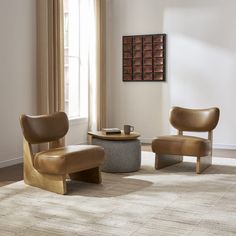 a living room with two chairs and a coffee table in front of a large window