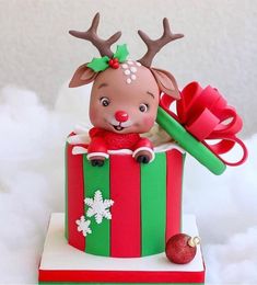 a christmas cake decorated with reindeers and presents