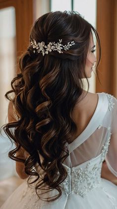 a woman with long hair wearing a white dress and a tiara on her head