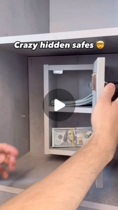 a person is opening a safe with money in the other hand and it says crazy hidden safes