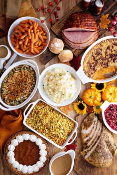 a table topped with lots of different types of food and desserts next to each other