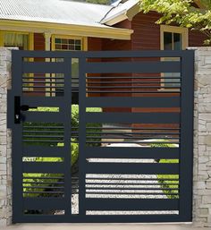 an iron gate is open in front of a house