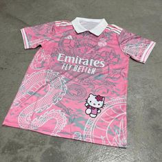 Show off your unique style and support your favorite team with the Custom Real Madrid Hello Kitty Jersey Tshirt. This piece perfectly blends the iconic Real Madrid branding with the adorable charm of Hello Kitty, creating a fun and stylish look that's perfect for fans of all ages. Crafted from high-quality fabric, this jersey T-shirt ensures you stay comfortable whether you're cheering on your team at the stadium or hanging out with friends. Specifications: Floral Pattern: Hello Kitty Sleeve Len Custom Soccer Jerseys, Hello Kitty Jersey, Hello Kitty T-shirt, Baddie Outfits For School Swag, Pink Birthday Basket, Real Madrid Pfp, Real Madrid T Shirt, Black And Pink Hello Kitty, Emirates Jersey