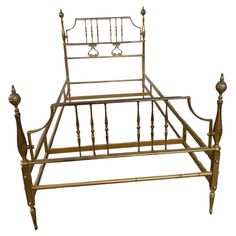 an antique brass bed frame with metal posts