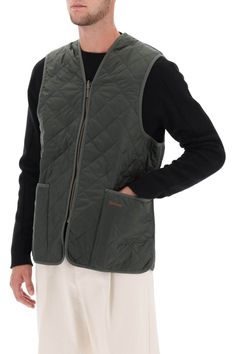 Find BARBOUR Quilted Vest on Editorialist. Barbour quilted vest crafted in nylon with tonal fabric trims. It features V neck, zipper fastening and front patch pockets embellished with contrasting logo embroidery. Lined in tartan cotton on the inside. Regular fit with boxy cut. The model is 187 cm tall and wears size UK 40. Fitted Quilted Nylon Vest, Fall Vest, Waxed Cotton Jacket, Reversible Vest, Quilted Vest, Heritage Brands, Fabric Trim, Waxed Cotton, Logo Embroidery