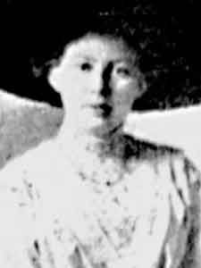 an old black and white photo of a woman wearing a hat