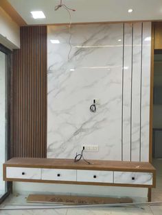 a large white marble wall in a room with wood trimmings and drawers on the side