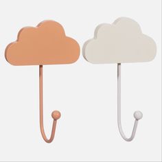 two wooden hooks with clouds on them, one is pink and the other is white