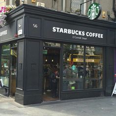 starbucks coffee shop on the corner of a city street