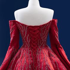 a red ball gown with silver beading on it