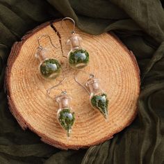 Whimsical earrings featuring preserved moss carefully encased in a glass vial and hung on stainless steel hooks. Perfect addition to Renaissance Faire outfits. Moss Earrings, Moss Jewelry, Whimsical Earrings, Preserved Moss, Glass Vials, Jewellery Ideas, Art Stuff, Halloween Shopping, Jewelry Earrings Dangle