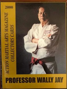 a man standing with his arms crossed in front of him, wearing a karate uniform