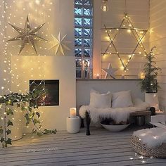 a living room filled with white furniture and lots of stars on the wall above it