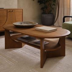 a wooden table with a book on top of it in a living room next to a chair