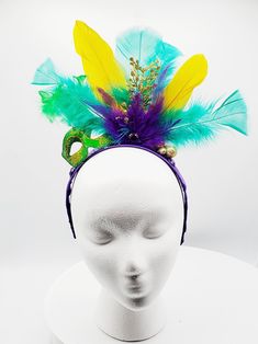 Mardi Gras headband made with purple, gold and green feathers with gold sparkle embellishments. Green masquerade mask with gold glitter detail and feathers. Headband wrapped with purple ribbon. Perfect for Mardi Gras celebration, carnival, festival or photoshoot. Adjustable Headband For Mardi Gras Costume Party, Adjustable Headpiece For Mardi Gras Party, Adjustable Masquerade Mask For Mardi Gras, Mardi Gras Party Headband, Headband For Mardi Gras Carnival, Mardi Gras Costume Party Headband, Carnival Costume Hats And Headpieces With Matching Headband, Gold Headpiece For Mardi Gras Carnival, Purple Carnival Headpiece For Party