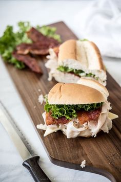 grilled turkey sub with pepper jack cheese and bacon on a cutting board next to a knife