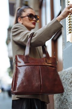 "This Brown cowhide leather bag is 100% handmade. this large tote bag is suitable for carrying everything in your everyday life. It has a Zipper Closure and Cross-Body strap. The bag has a cotton lining and it has 3 inner pockets. as you can see it made by really high-quality Italian leather.this leather calls \"Pelle Conciata Al Vegetale\", which means that the leather is tanned with only natural materials. Dimentions: - Width ( top of the bag ) : 32 Cm / 12.5'' ( Bottom of the bag ) : 37 Cm / Elegant Large Capacity Brown Weekender Bag, Elegant Brown Large Capacity Weekender Bag, Everyday Brown Tote Shoulder Bag, Leather Shoulder Bag With Handle Drop For Everyday Use, Brown Briefcase With Double Handle, Brown Briefcase With Double Handle And Handle Drop, Chic Brown Leather Shoulder Backpack, Leather Hobo Tote Bag For Business, Brown Tote Shoulder Bag With Handles