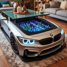 a table that looks like a bmw car in the middle of a living room with couches