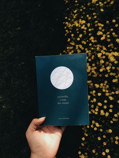 a person holding up a book in their hand