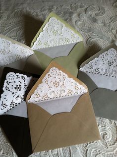 four envelopes with lace doily on them