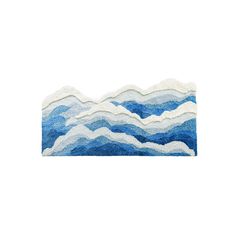 a blue and white rug with waves on it's sides, against a white background