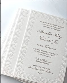 a white wedding card on top of a table