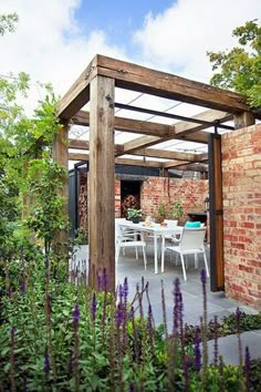 an outdoor dining area with table and chairs