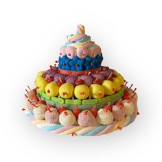 there is a cake made out of different types of candies and fruits on it